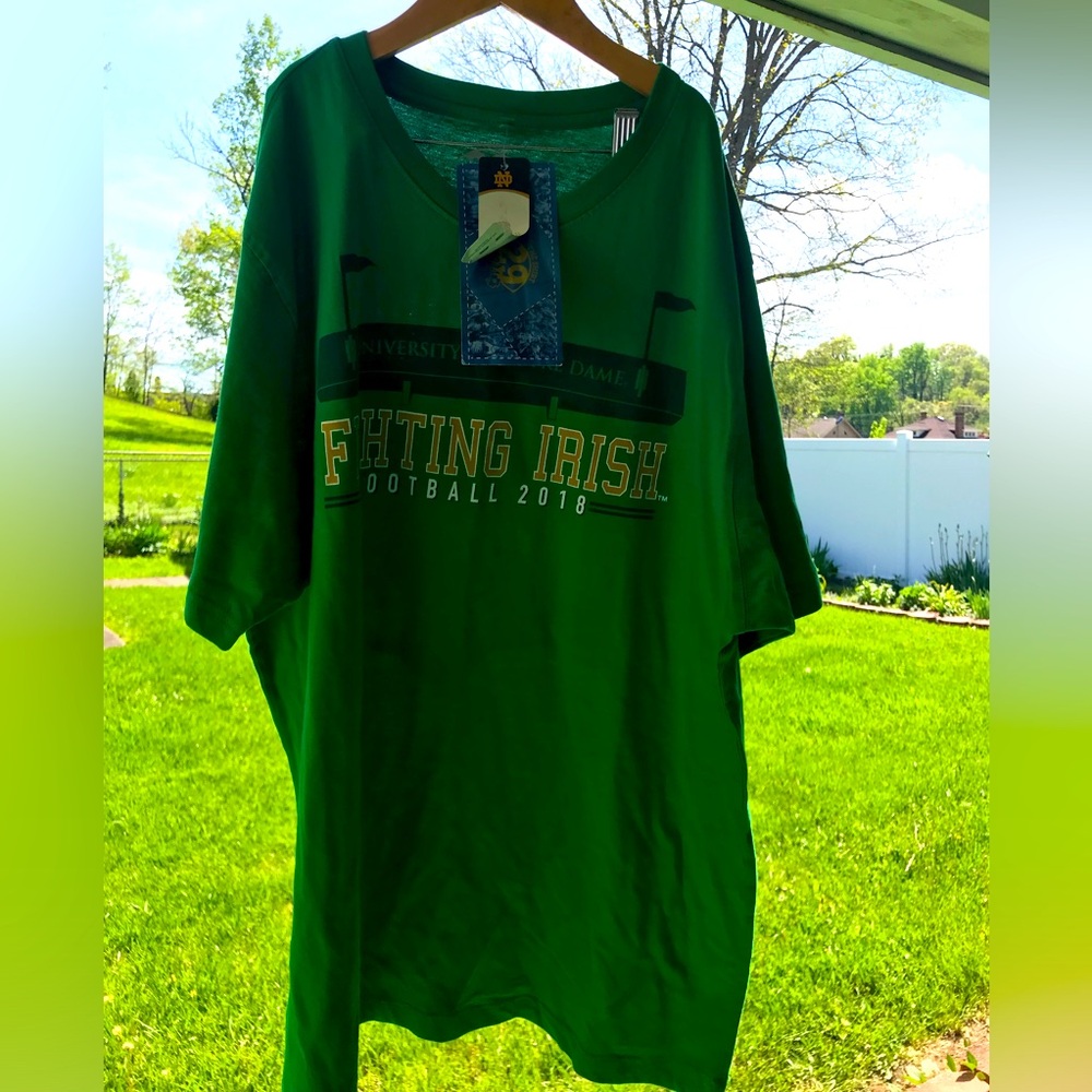 NWT. Notre Dame football T-shirt with printing on the back, front and sleeve.